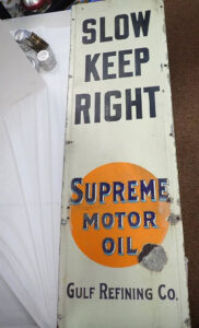 "Slow Keep Right" Supreme Motor Oil" metal sign - sold at auction for $3500 by Central Mass Auctions