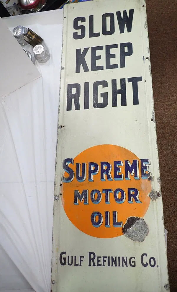 "Slow Keep Right" Supreme Motor Oil" metal sign - sold at auction for $3500 by Central Mass Auctions