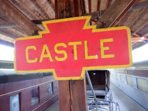 Wooden "Castle" Railroad Station Sign - sold for $2250 at auction by Central Mass Auctions